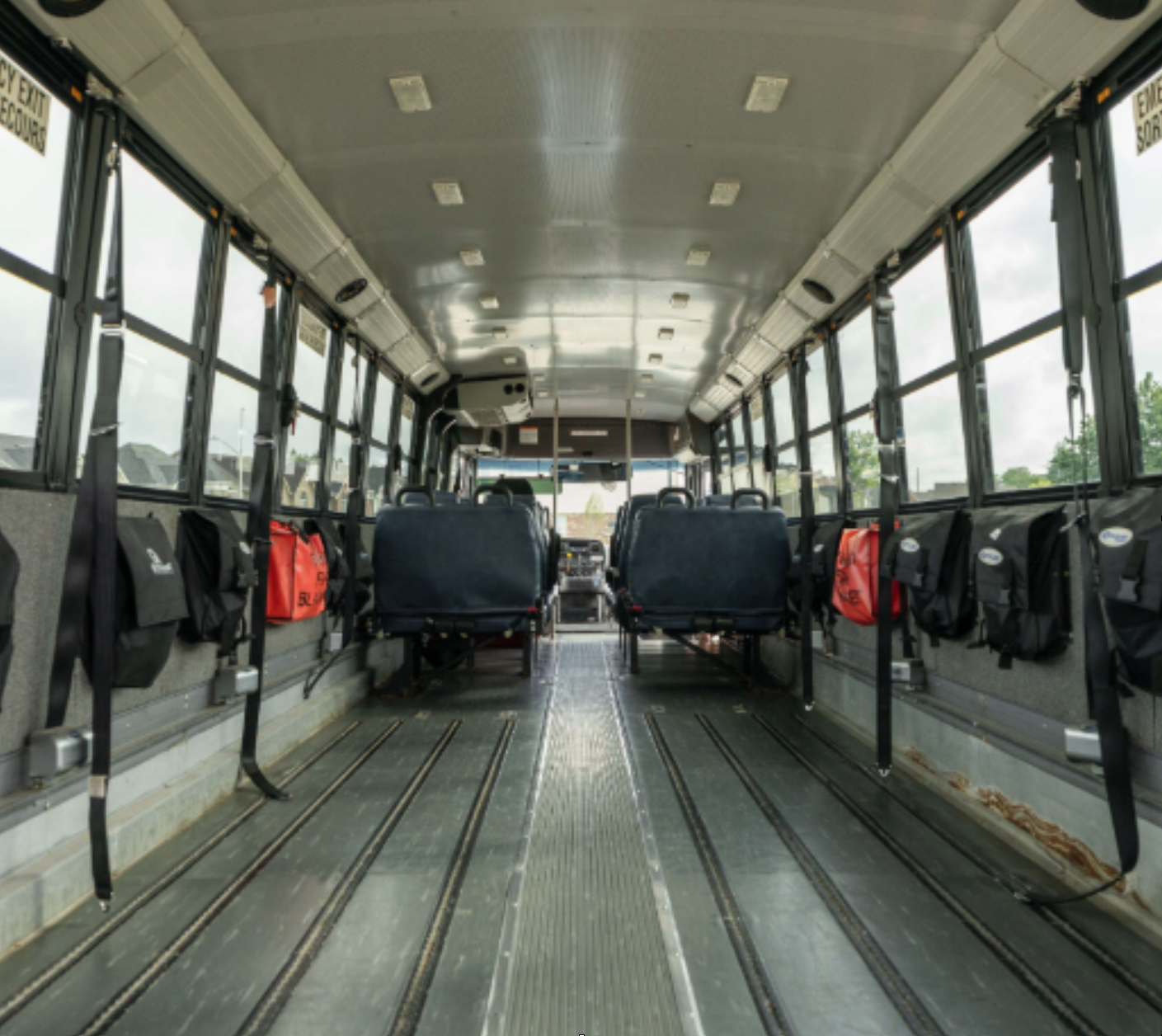 Wheelchair-accessible seating layout inside a Denny’s Bus Lines vehicle configured for mobility and ambulatory passengers