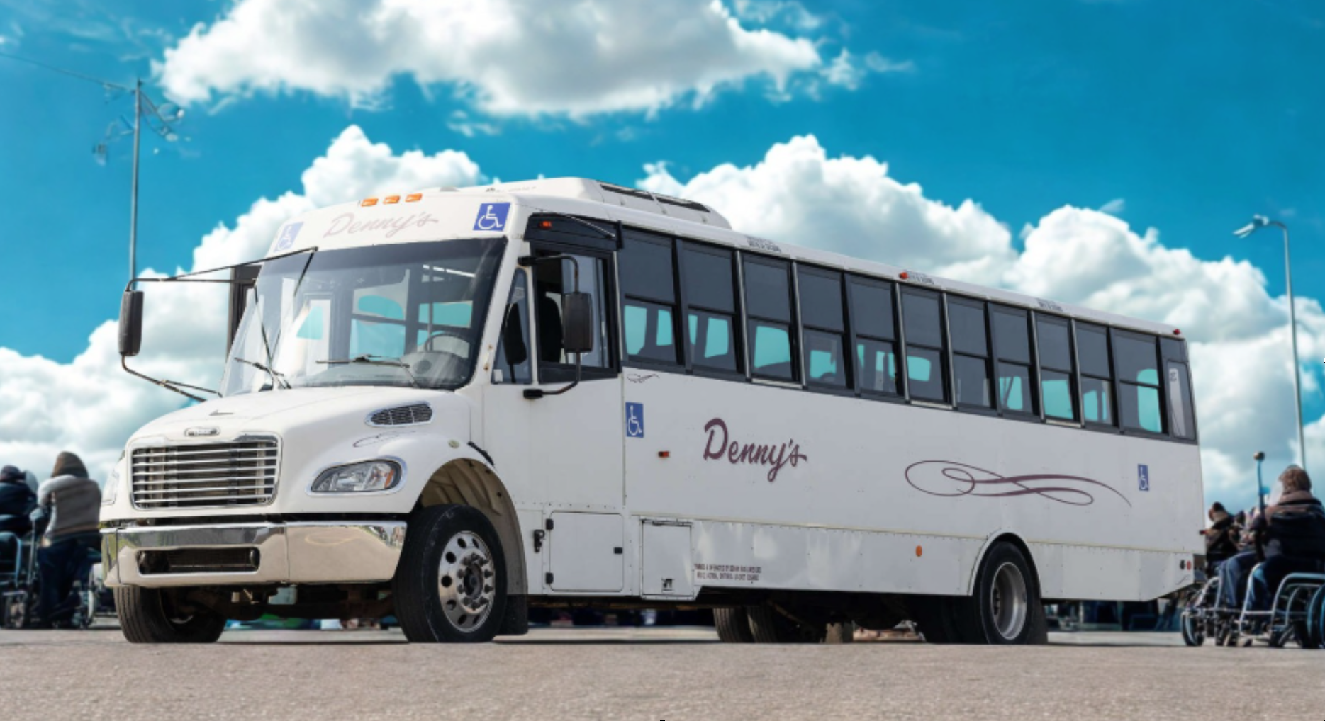 Passengers boarding a Denny’s Bus Lines accessible vehicle