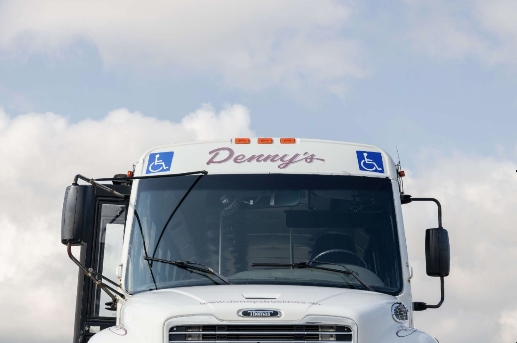 Accessible Denny’s Bus Lines coach transporting passengers comfortably through Ontario